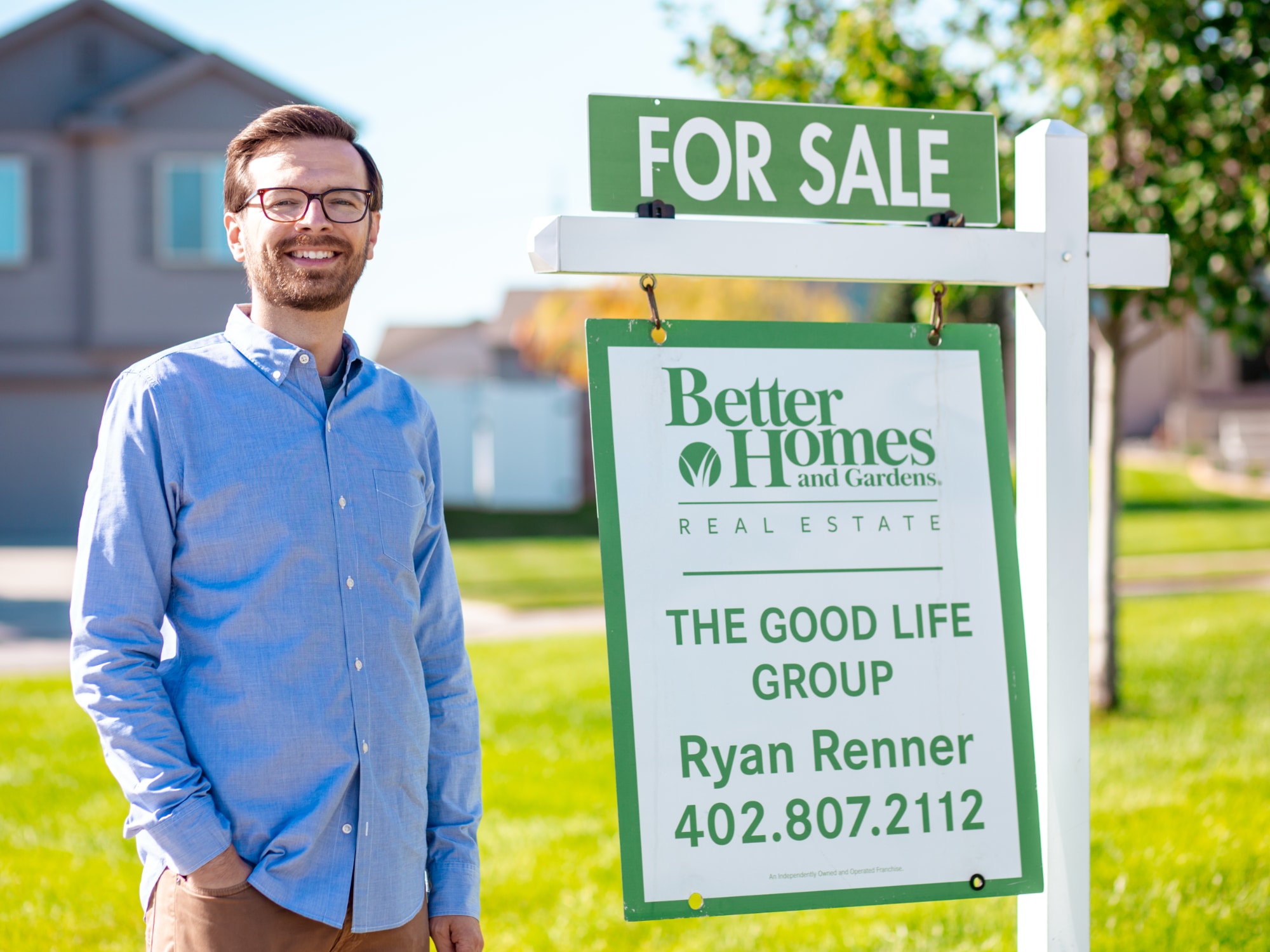 Ryan Renner standing next to a For Sale Sign
